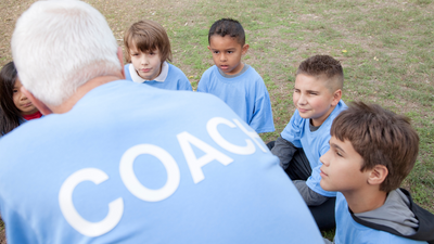Children listen to a coach