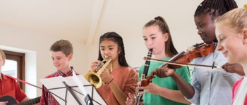 Children in a band playing musical instruments