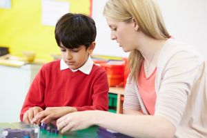 Teacher and pupil doing a task together