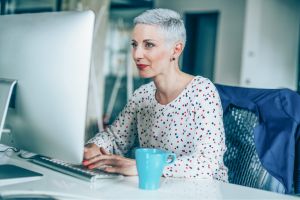 Lady looking at computer screen.