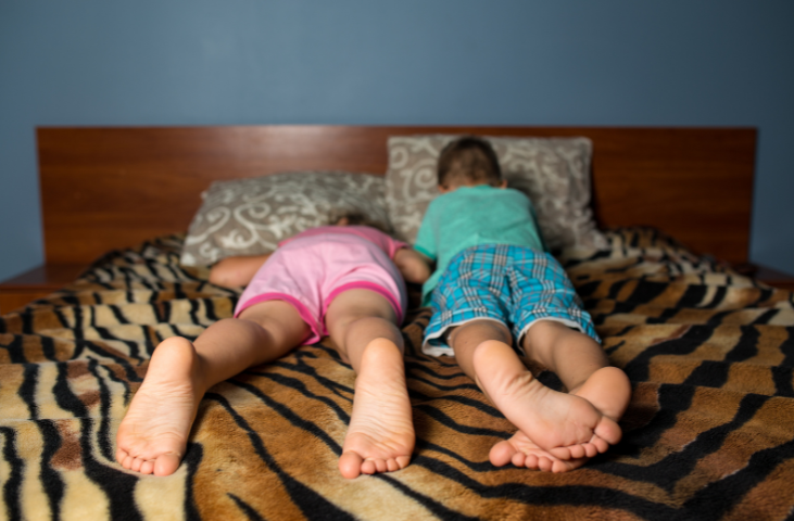 Two children on a bed