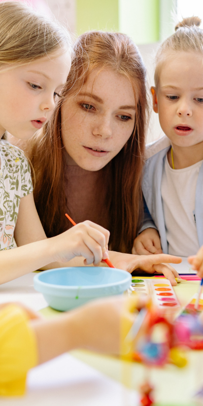 Adult supervising children in an early years setting