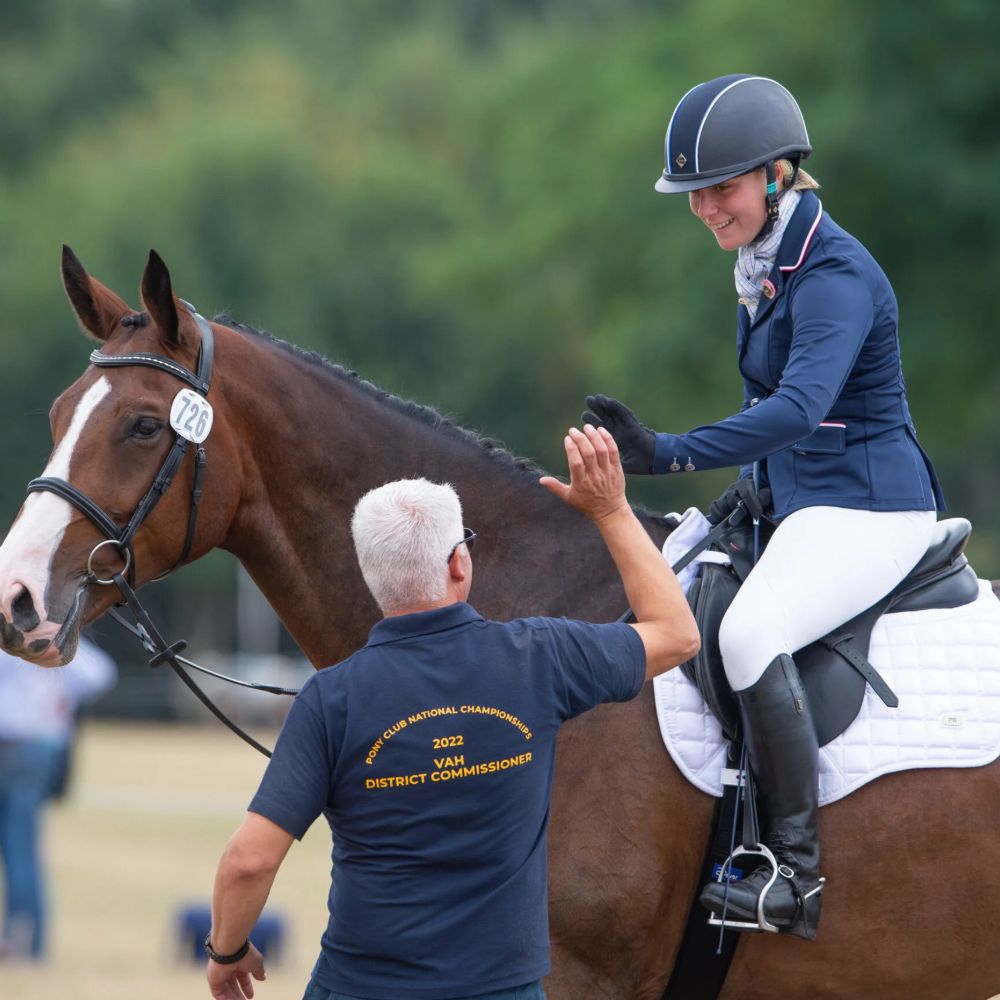 equestrian-sector-header-square Equestrian safeguarding lead guiding a child riding a horse