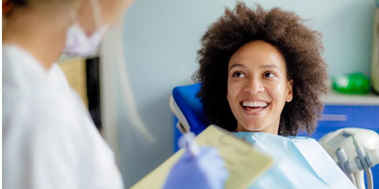 Smiling patient talking to a dental nurse