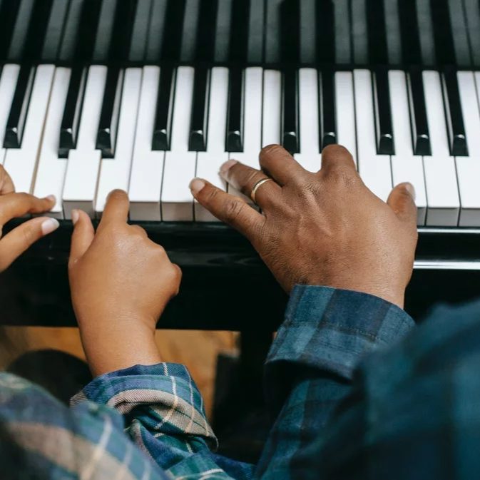 music-sector-header-square Child's hands playing a piano