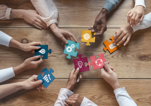 Atable with hands showing different cards to represent different consultancy packages