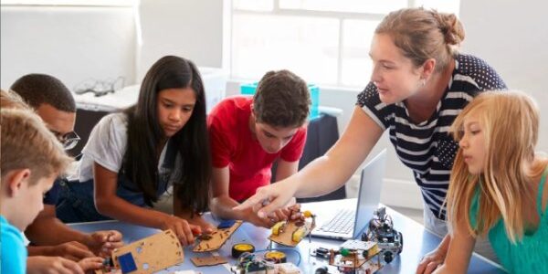 clubs-thumbnail-2 Club leader helping children build robots at an after-school club
