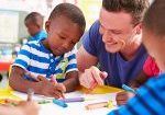 sieey Boy and teacher in an early years setting